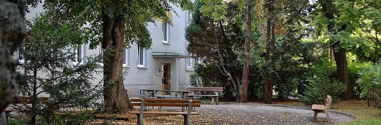 Begrünter Innenhof einer Wohnanlage mit mehreren Fassaden